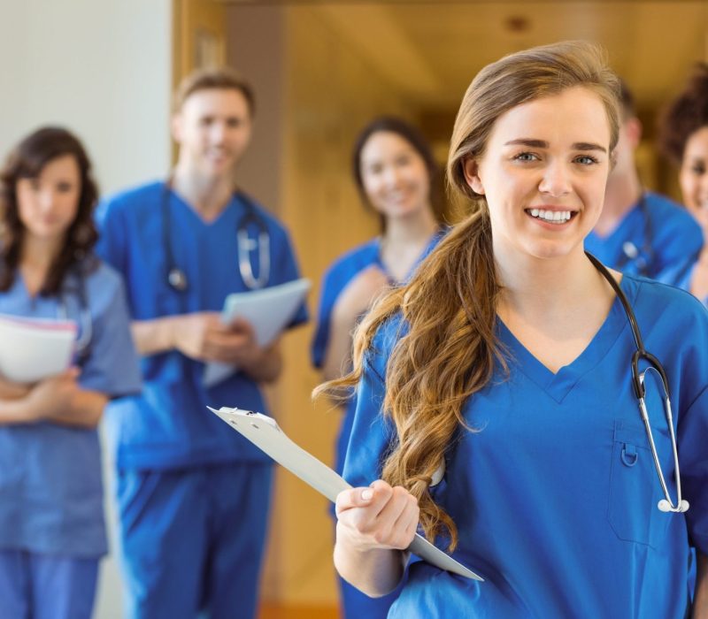 Medical students smiling at the camera at the university